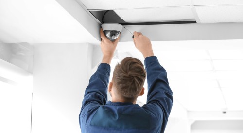 SMB technician installing a security camera