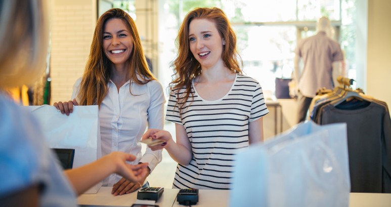 Two women checking out at a retail SMB