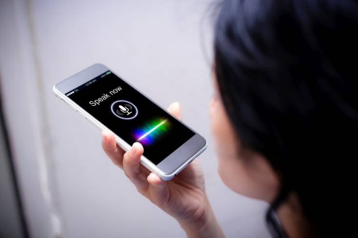 A woman using her phone for Voice Search